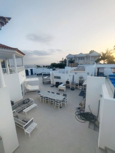 The terrace at dusk with a glimpse of the sea