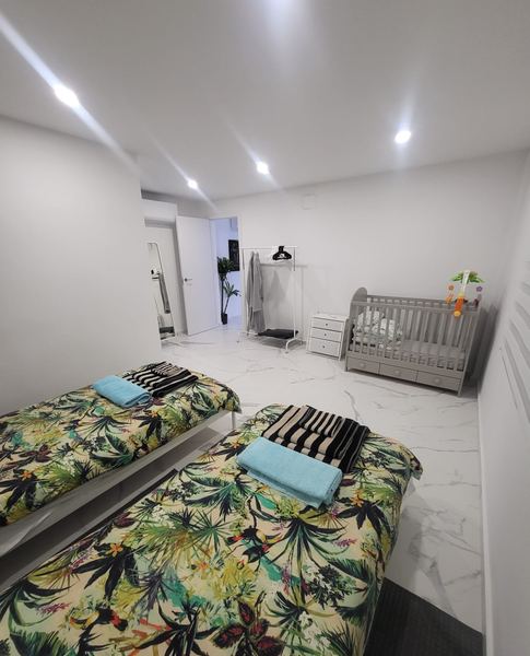 Twin bedroom with a baby cot